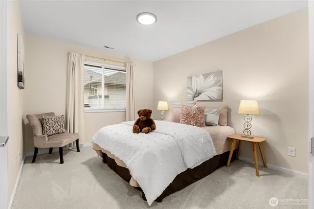 a bedroom with a bed and a chair