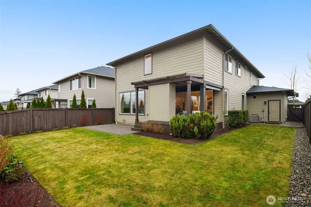 a view of a house with backyard and porch