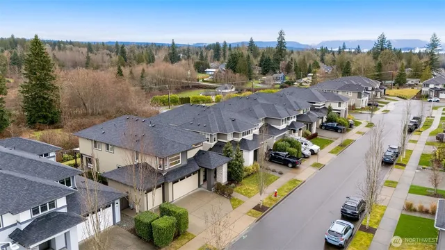 an aerial view of a house with garden space and street view