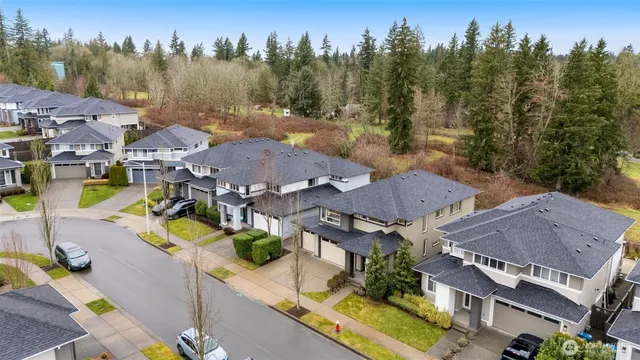 an aerial view of a houses with a swimming pool