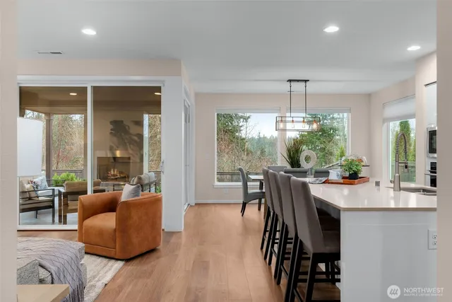 a dining room with furniture a chandelier and wooden floor