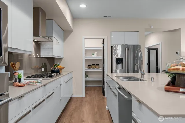 a kitchen with a sink stove and refrigerator