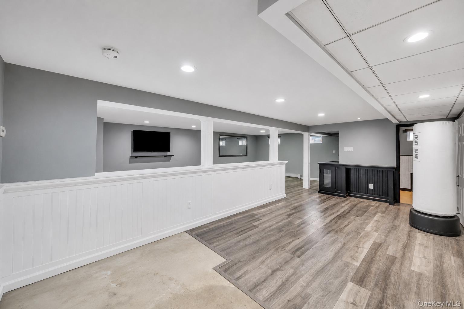 19 Joan Road Bay Shore, NY 11706 - Photo 38 of 50 Spacious lower level featuring wood-finish flooring, recessed lighting, and a built-in wet bar with a beverage refrigerator