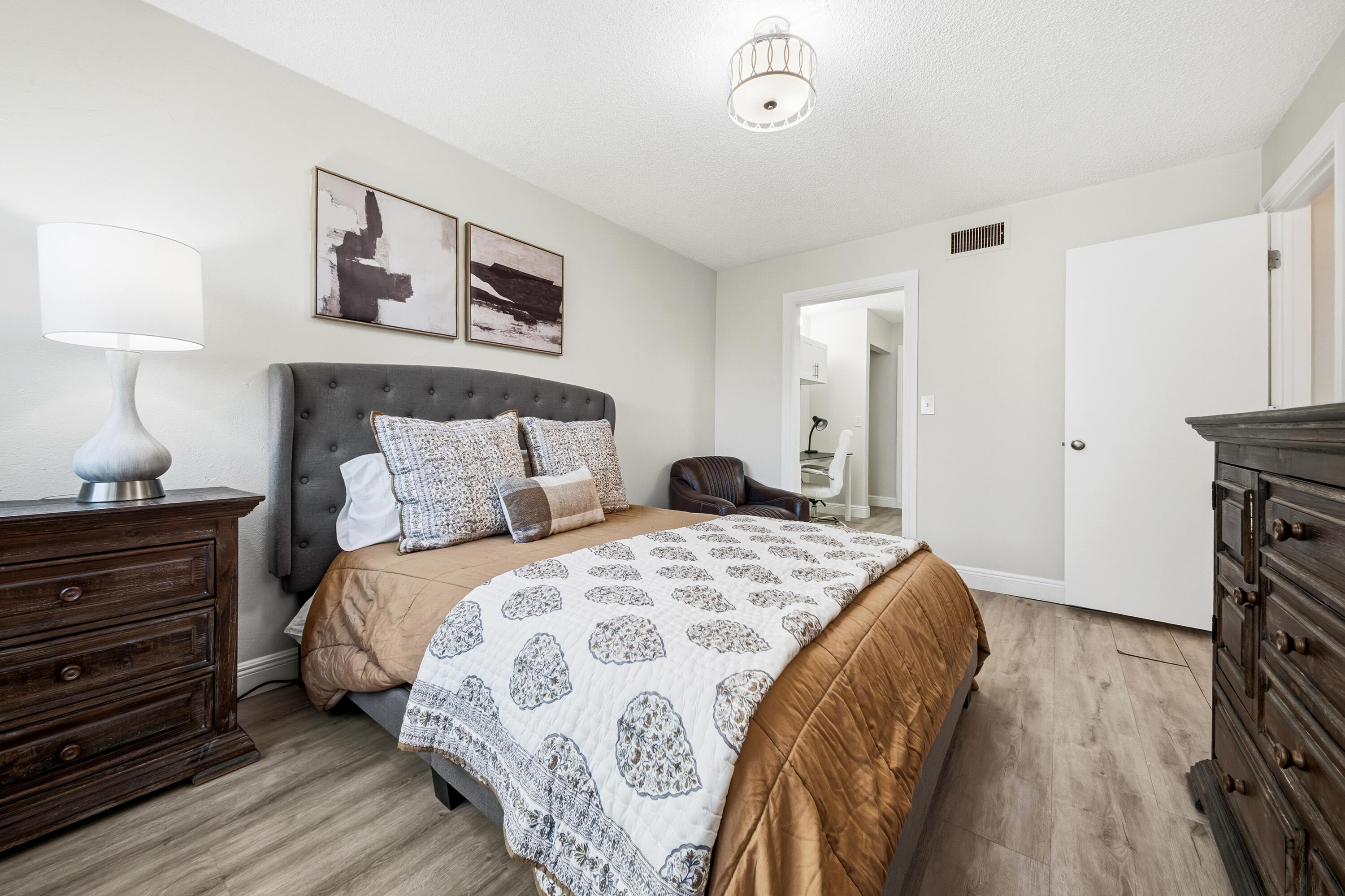 9440 Southwest 8th Street, Unit 314 Boca Raton, FL 33428 - Photo 12 of 30 a spacious bedroom with a bed and a lamp