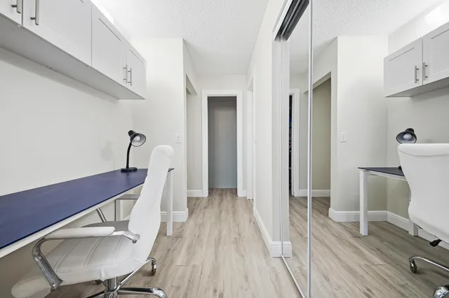 a view of a room with wooden floor lounge chair and windows
