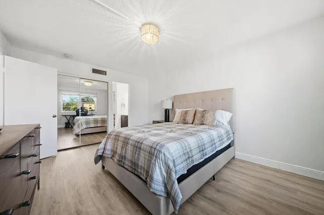 a bedroom with a bed couch and a window