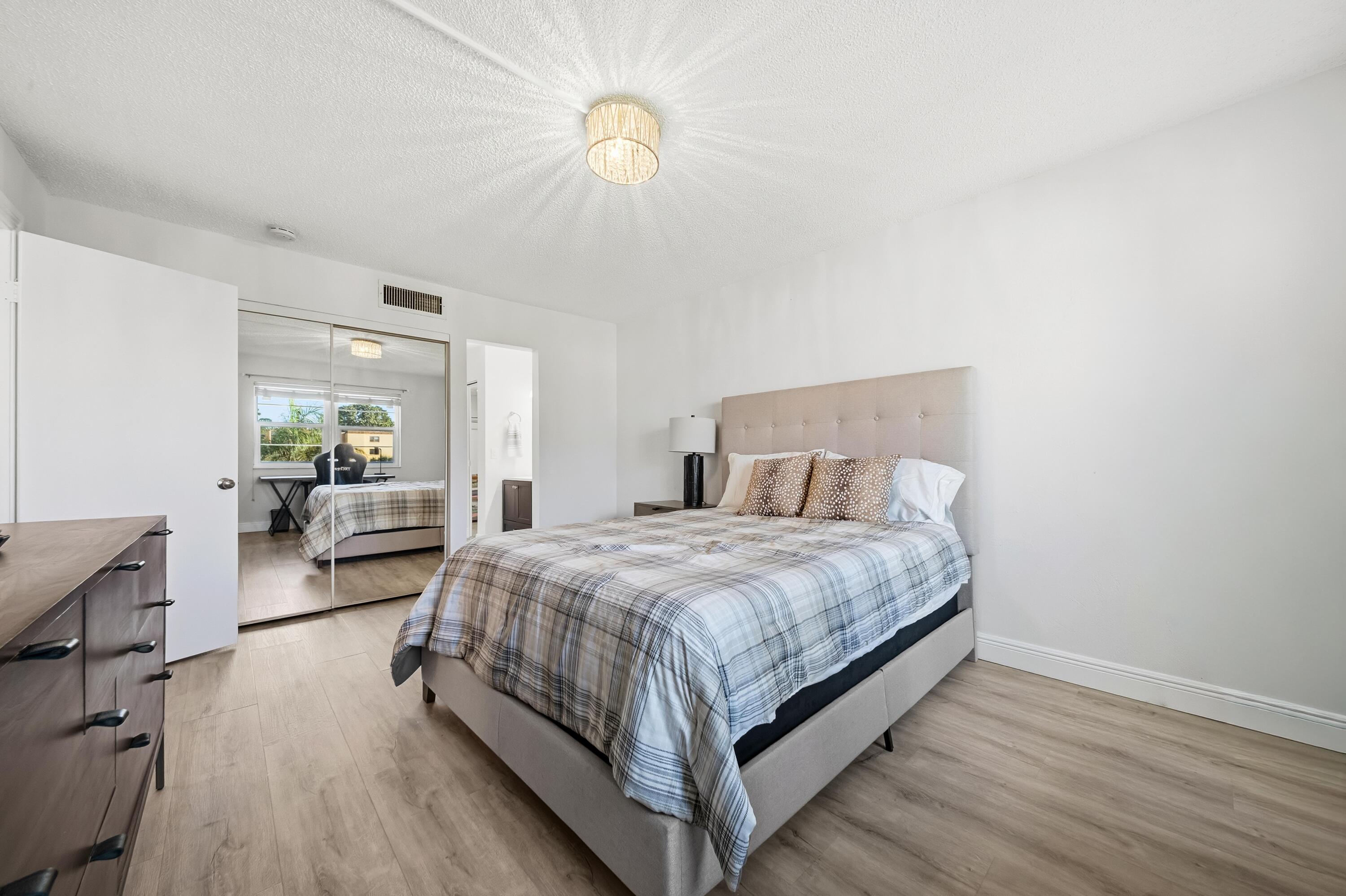 9440 Southwest 8th Street, Unit 314 Boca Raton, FL 33428 - Photo 14 of 30 a bedroom with a bed couch and a window