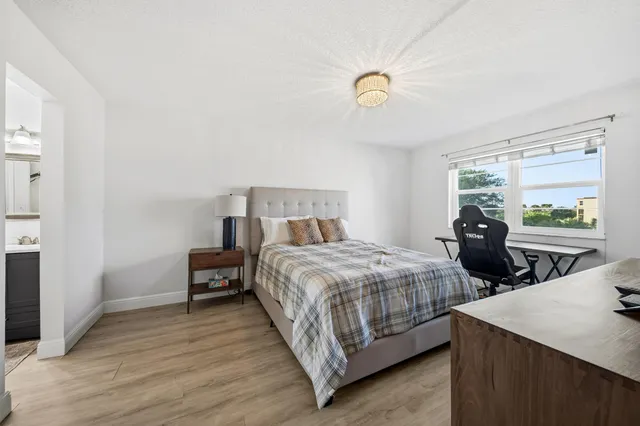 a bedroom with two beds and a dresser