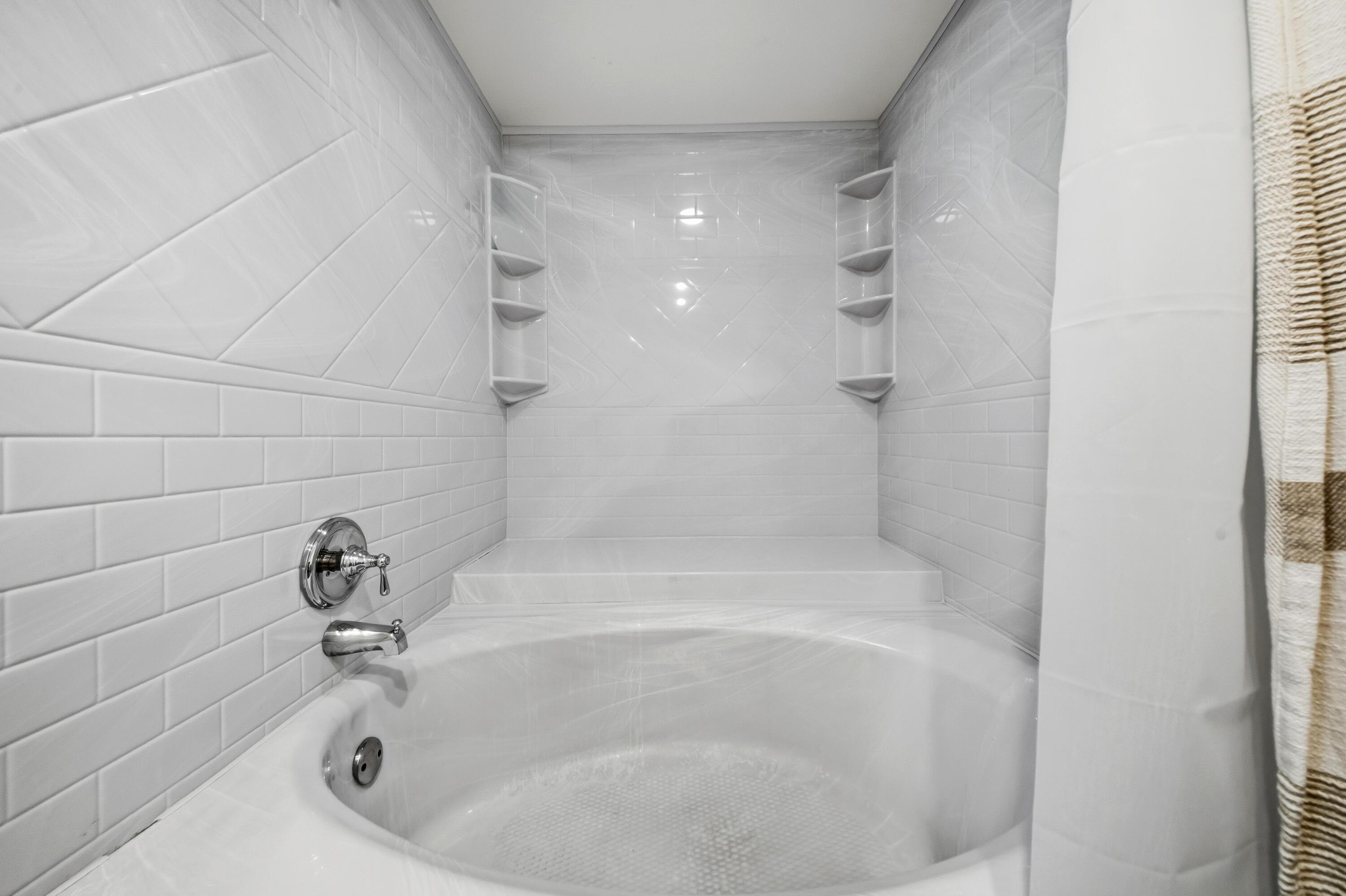 9440 Southwest 8th Street, Unit 314 Boca Raton, FL 33428 - Photo 18 of 30 a close up of a bathtub in a bathroom
