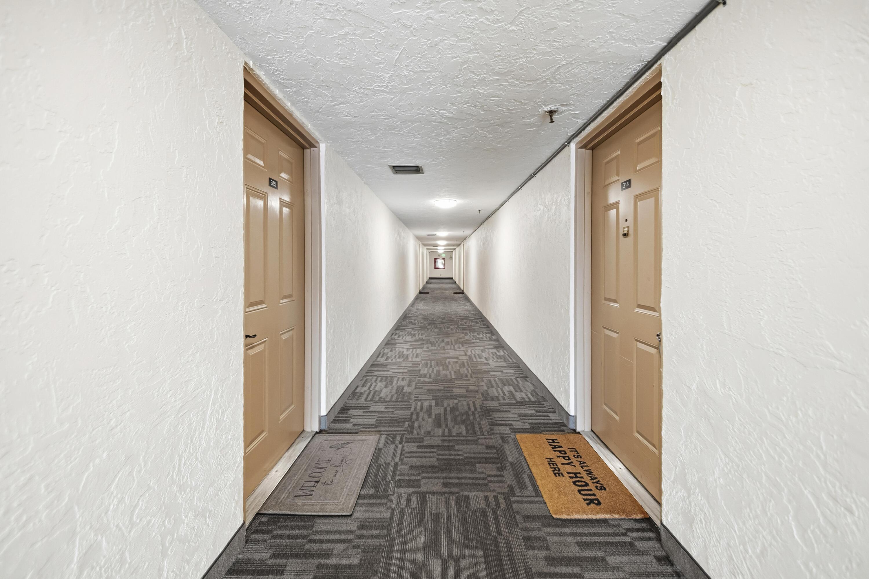 9440 Southwest 8th Street, Unit 314 Boca Raton, FL 33428 - Photo 23 of 30 a view of a hallway with wooden floor and staircase