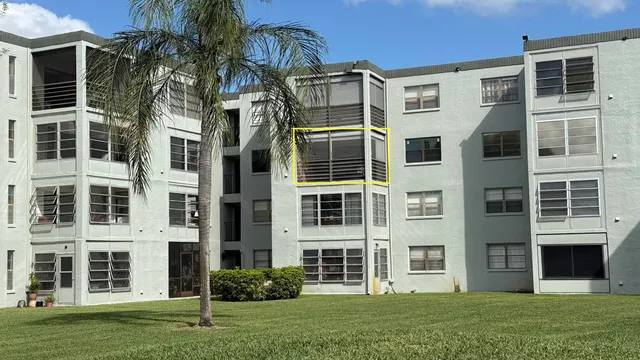 a front view of a residential apartment building with a yard
