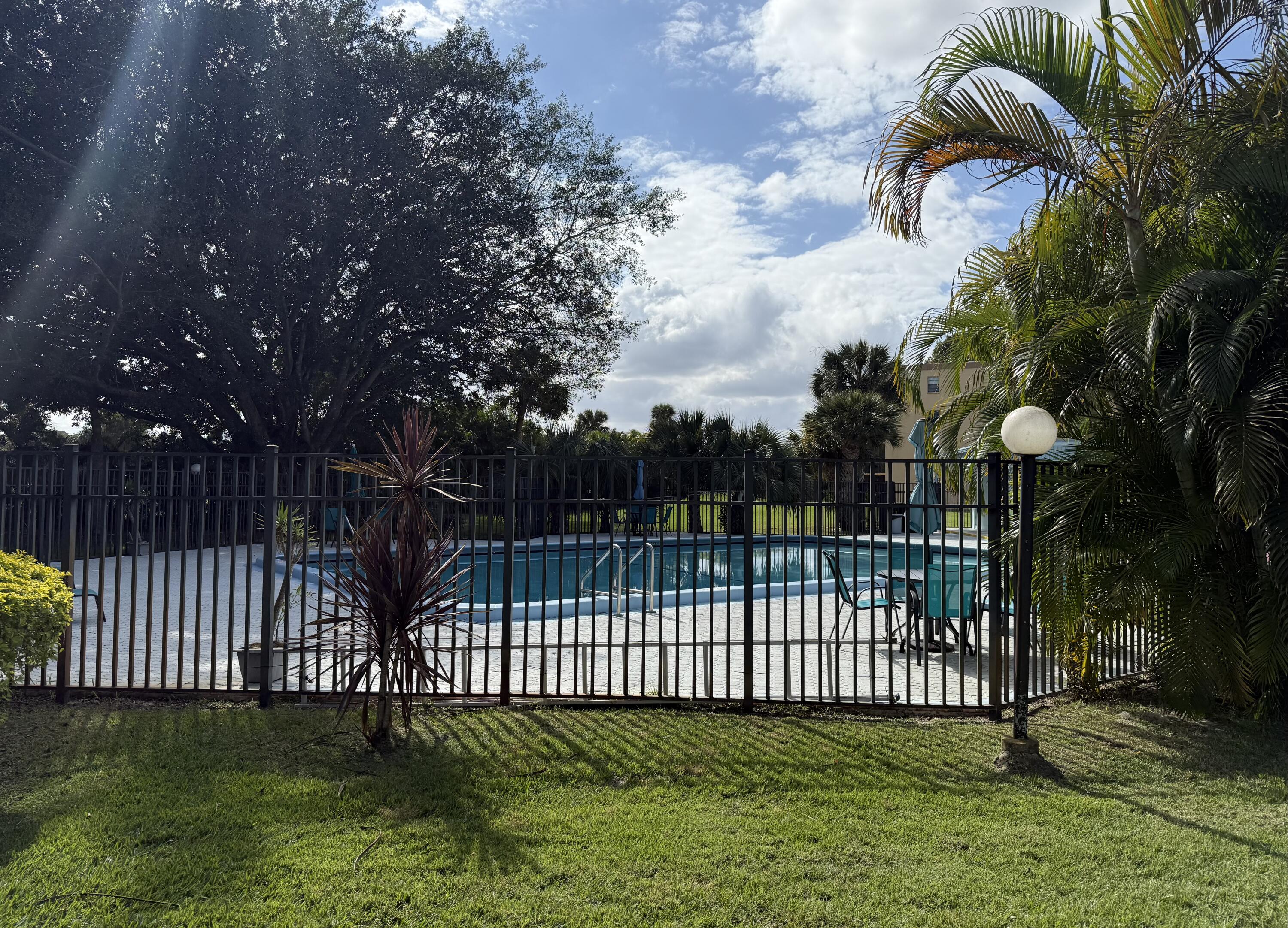 9440 Southwest 8th Street, Unit 314 Boca Raton, FL 33428 - Photo 27 of 30 a view of a wrought iron fences in front of house