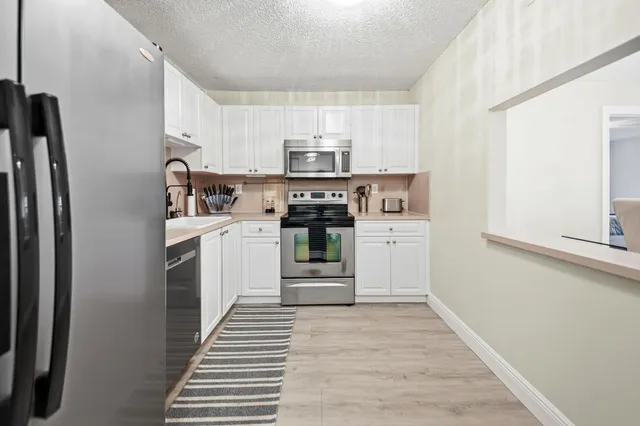 a kitchen with stainless steel appliances a stove and a refrigerator