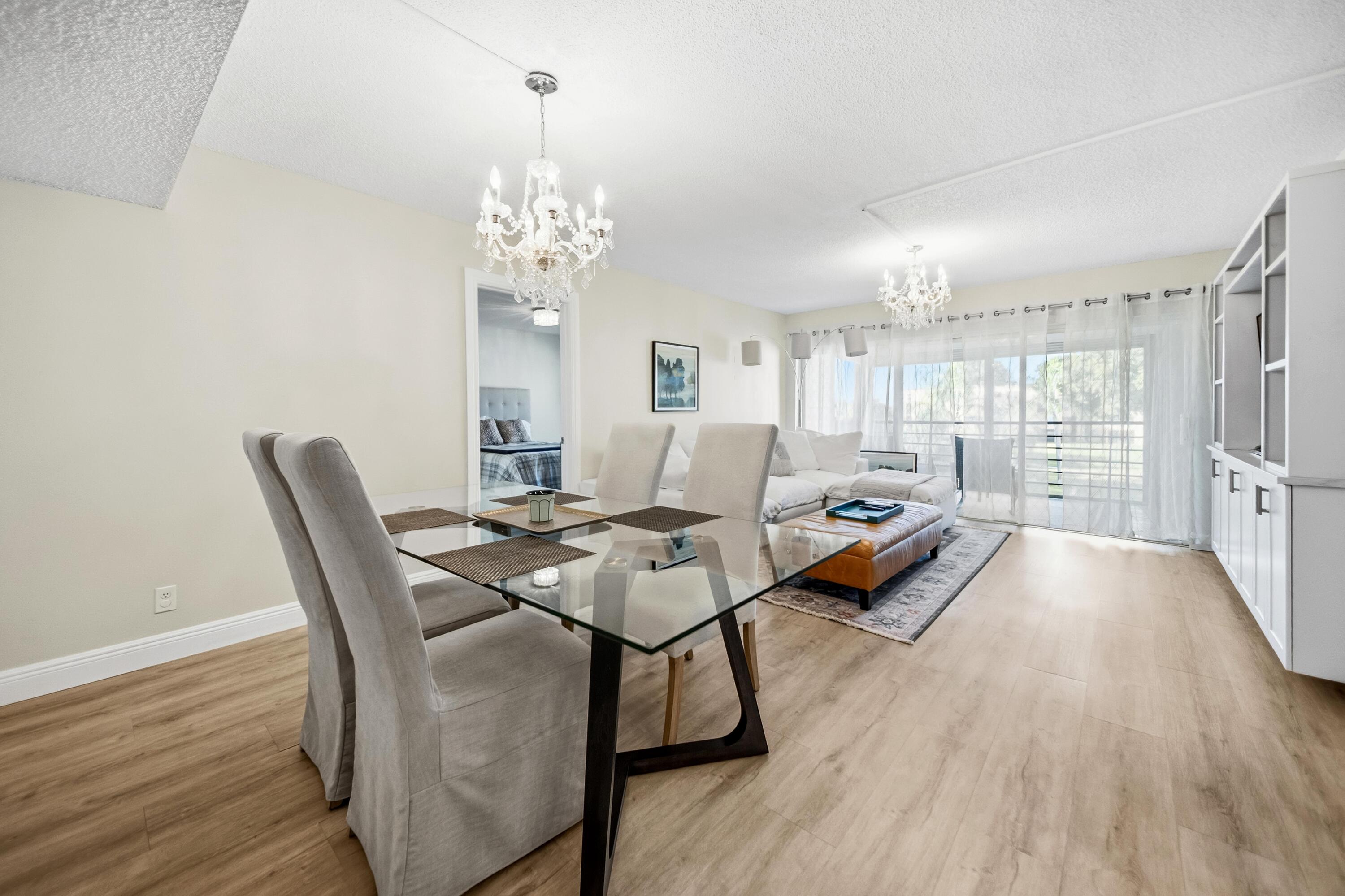 9440 Southwest 8th Street, Unit 314 Boca Raton, FL 33428 - Photo 4 of 30 a living room with furniture and a chandelier