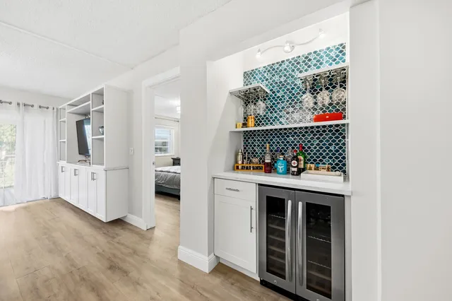 a view of utility room and wooden floor
