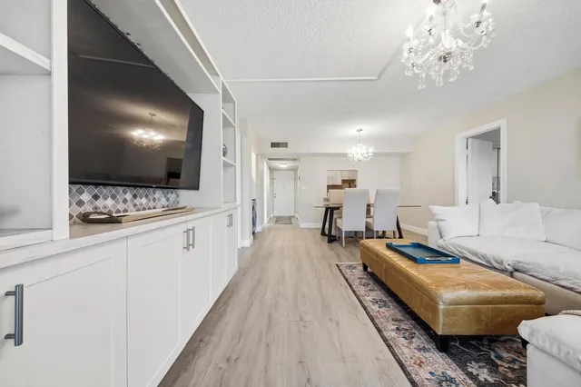 a spacious bedroom with a bed and a flat screen tv