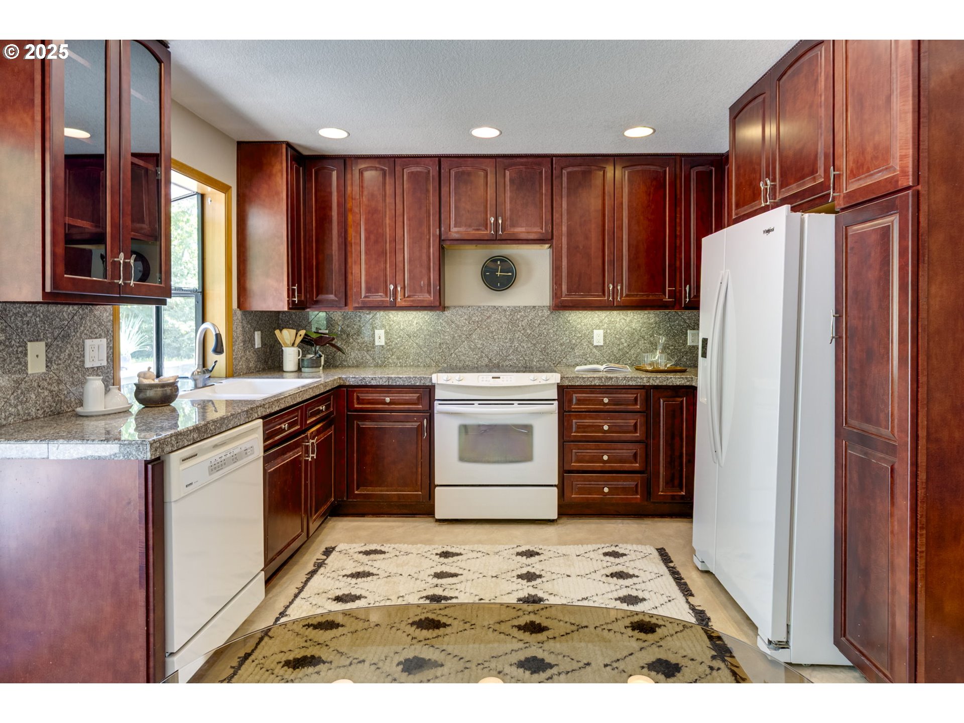985 Cornell Avenue Gladstone, OR 97027 - Photo 12 of 38 a kitchen with wooden cabinets and refrigerator