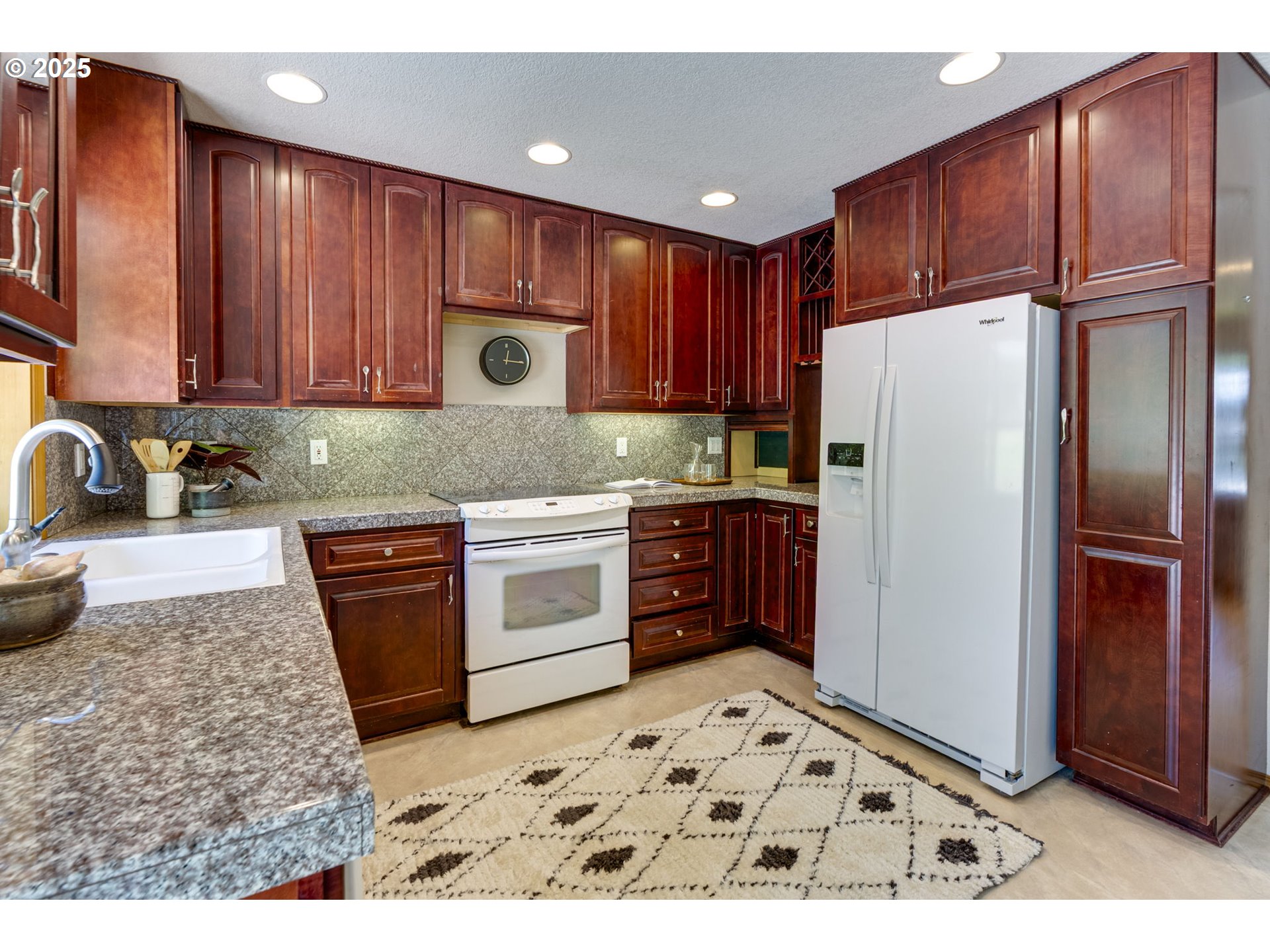 985 Cornell Avenue Gladstone, OR 97027 - Photo 13 of 38 a kitchen with stainless steel appliances granite countertop a refrigerator stove and sink