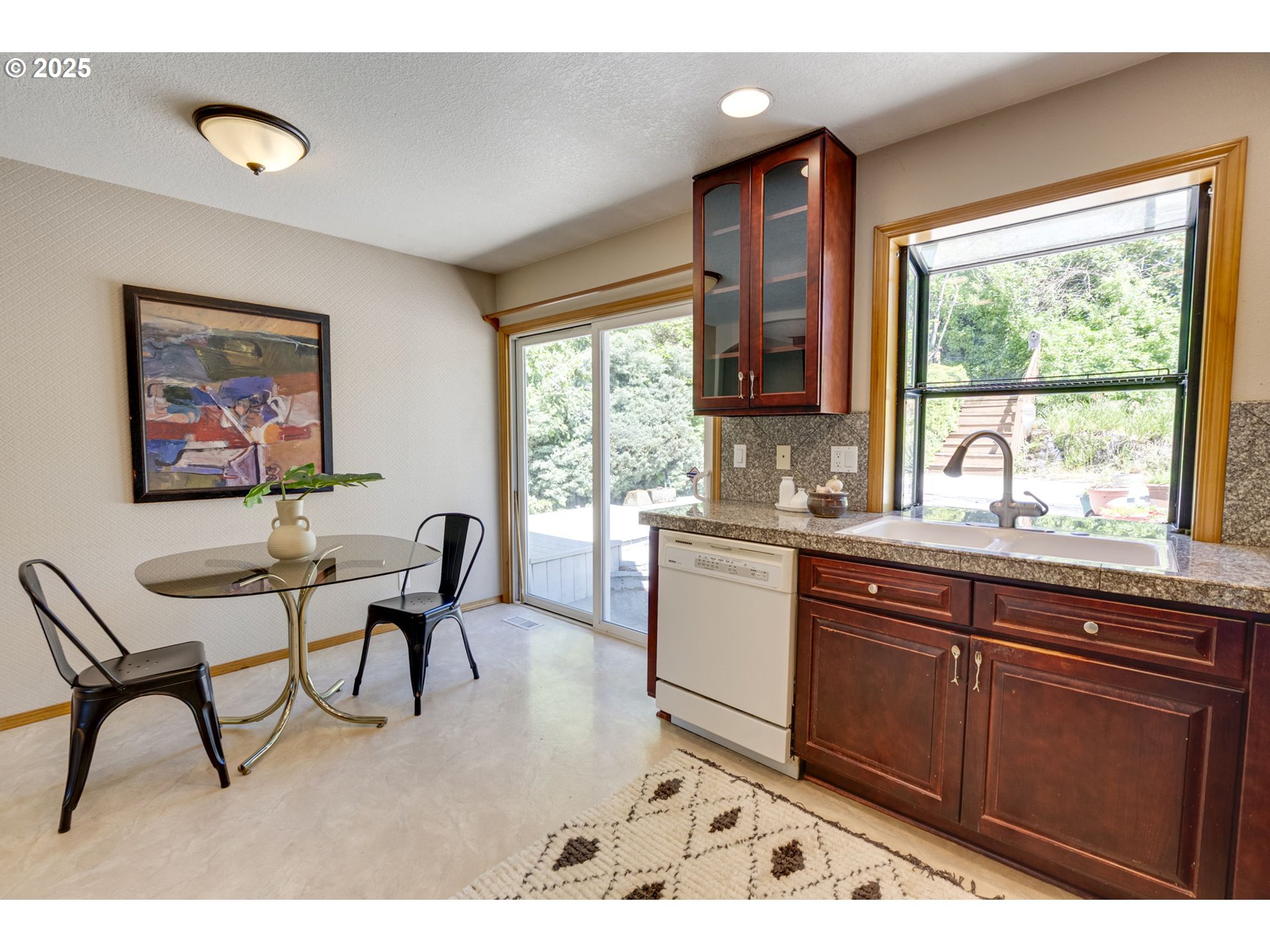 985 Cornell Avenue Gladstone, OR 97027 - Photo 15 of 38 a kitchen with a dining table chairs and large window