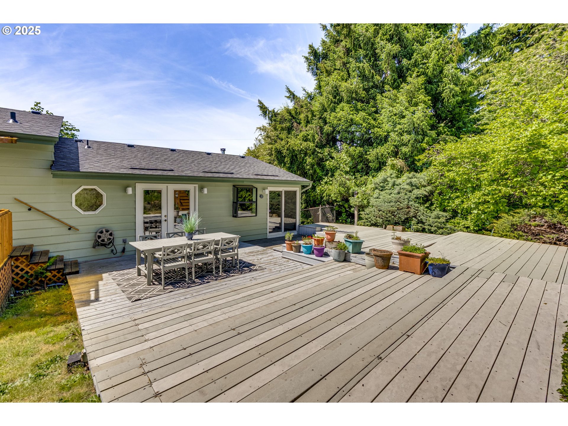 985 Cornell Avenue Gladstone, OR 97027 - Photo 35 of 38 a view of a roof deck with table and chairs a barbeque with wooden floor and fence