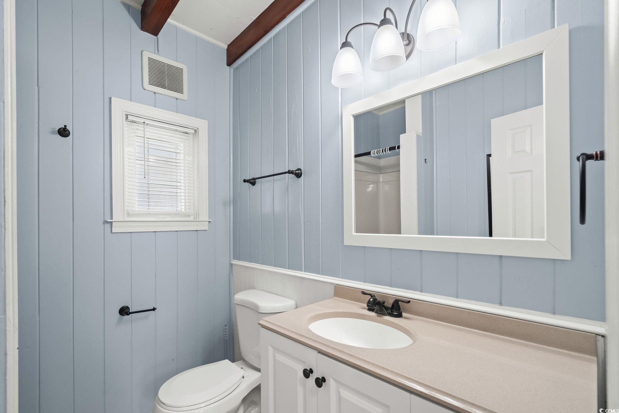 3402 Turner Street North Myrtle Beach, SC 29582 - Photo 12 of 26 Bathroom with wooden walls, vanity, a shower with shower curtain, and beam ceiling