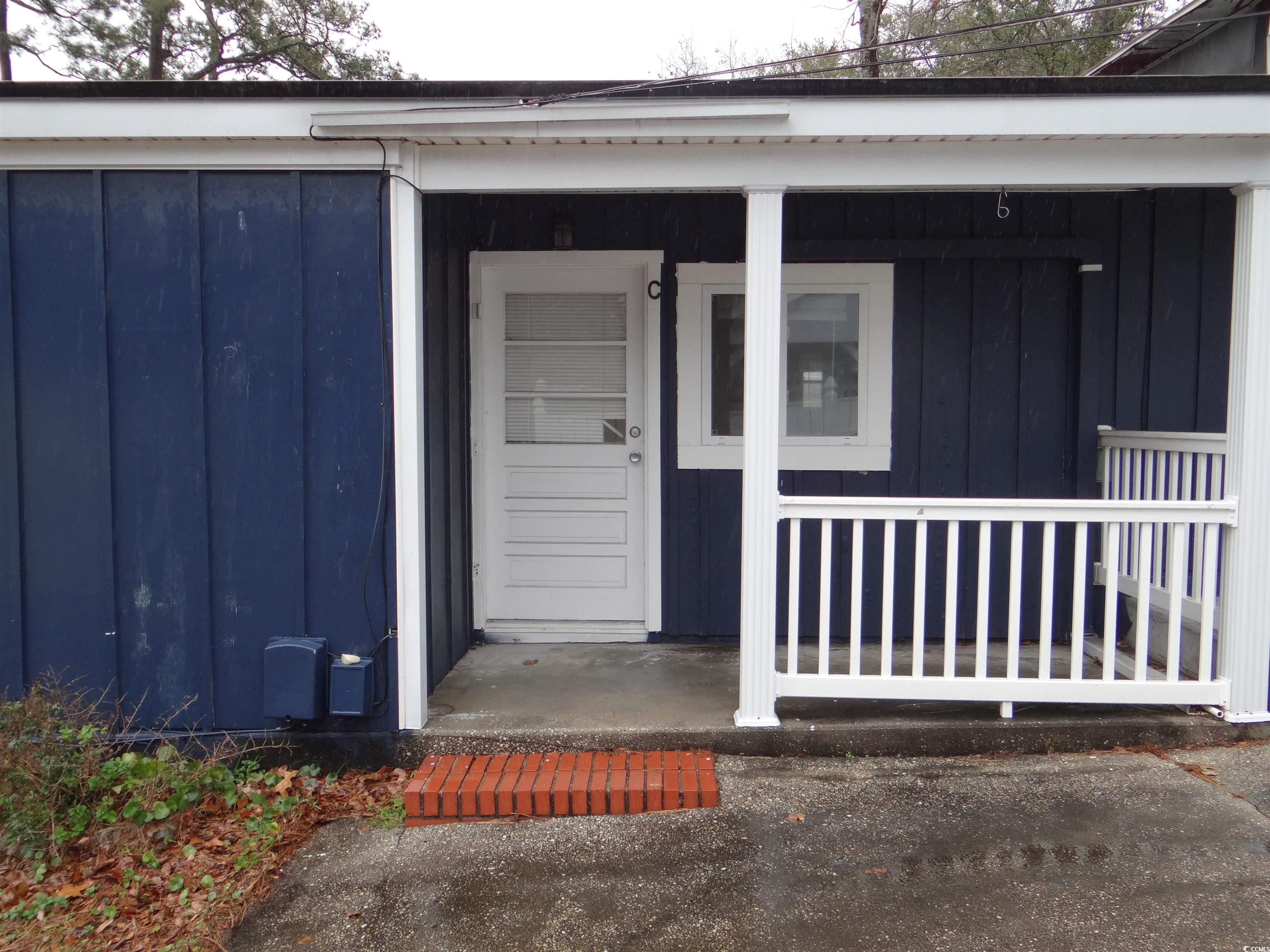 3402 Turner Street North Myrtle Beach, SC 29582 - Photo 16 of 26 Entrance to property featuring board and batten siding and a porch