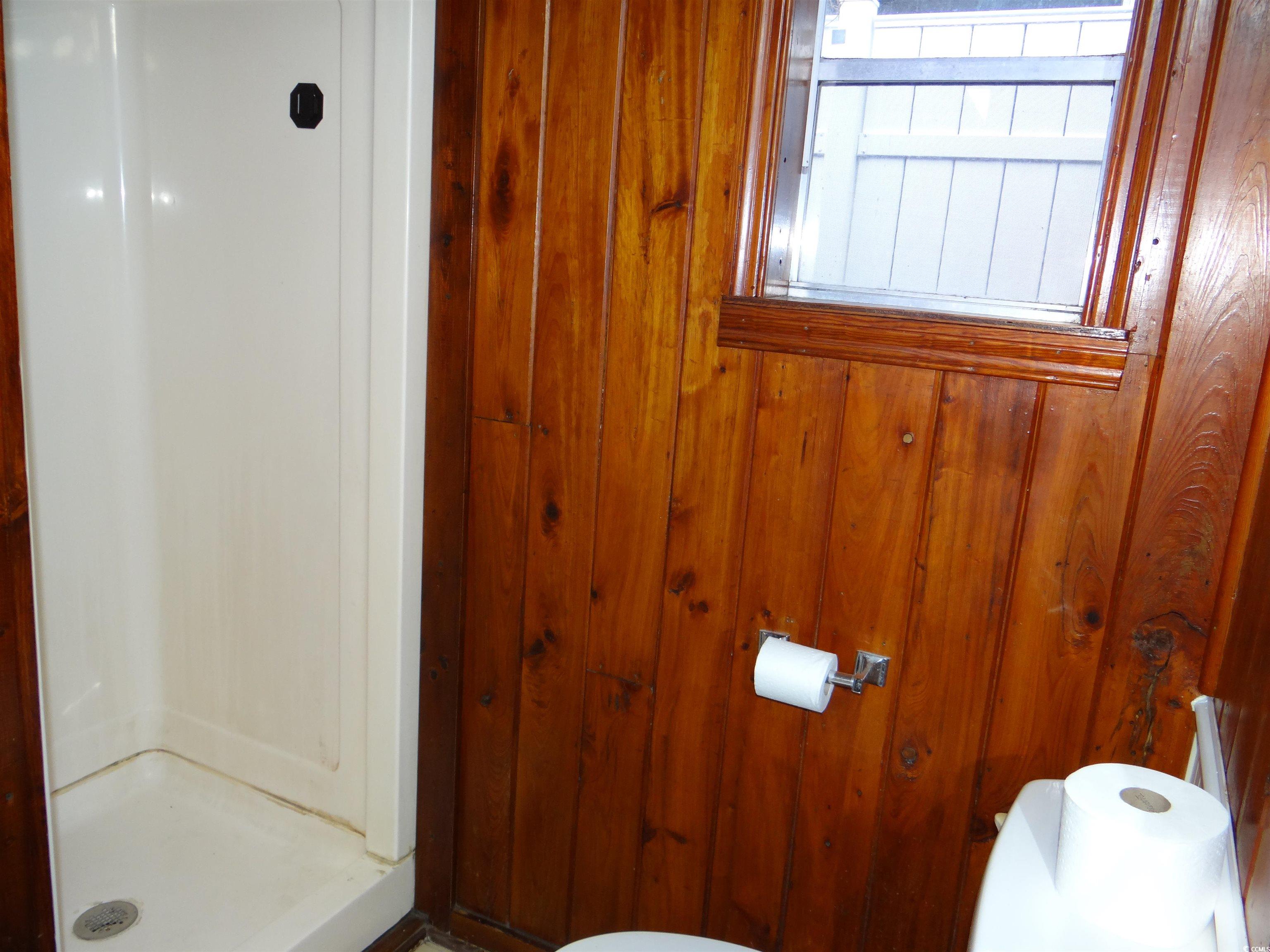 3402 Turner Street North Myrtle Beach, SC 29582 - Photo 23 of 26 Bathroom with a shower stall and wooden walls