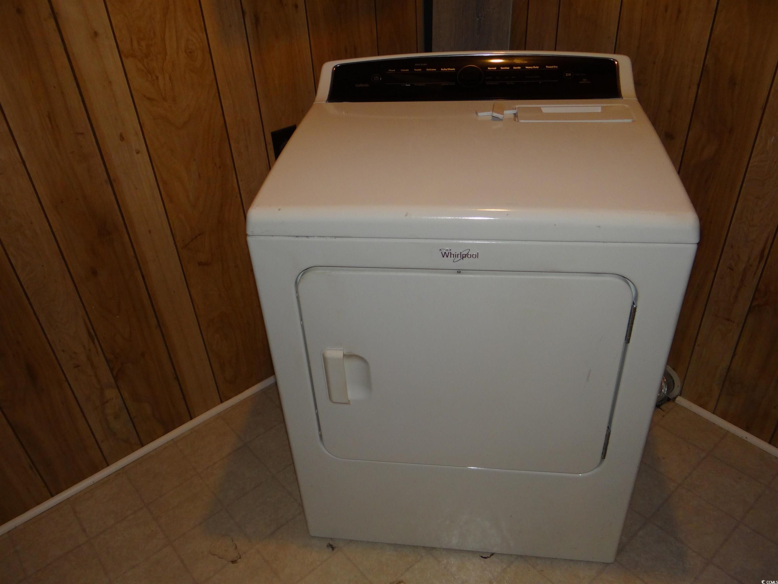 3402 Turner Street North Myrtle Beach, SC 29582 - Photo 25 of 26 Laundry room featuring washer / dryer, wooden walls, and light tile patterned flooring