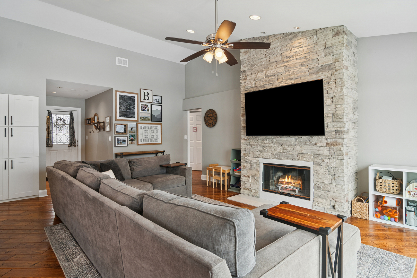 469 Pheasant Ridge Road Lake Zurich, IL 60047 - Photo 11 of 20 a living room with furniture a fireplace and a flat screen tv