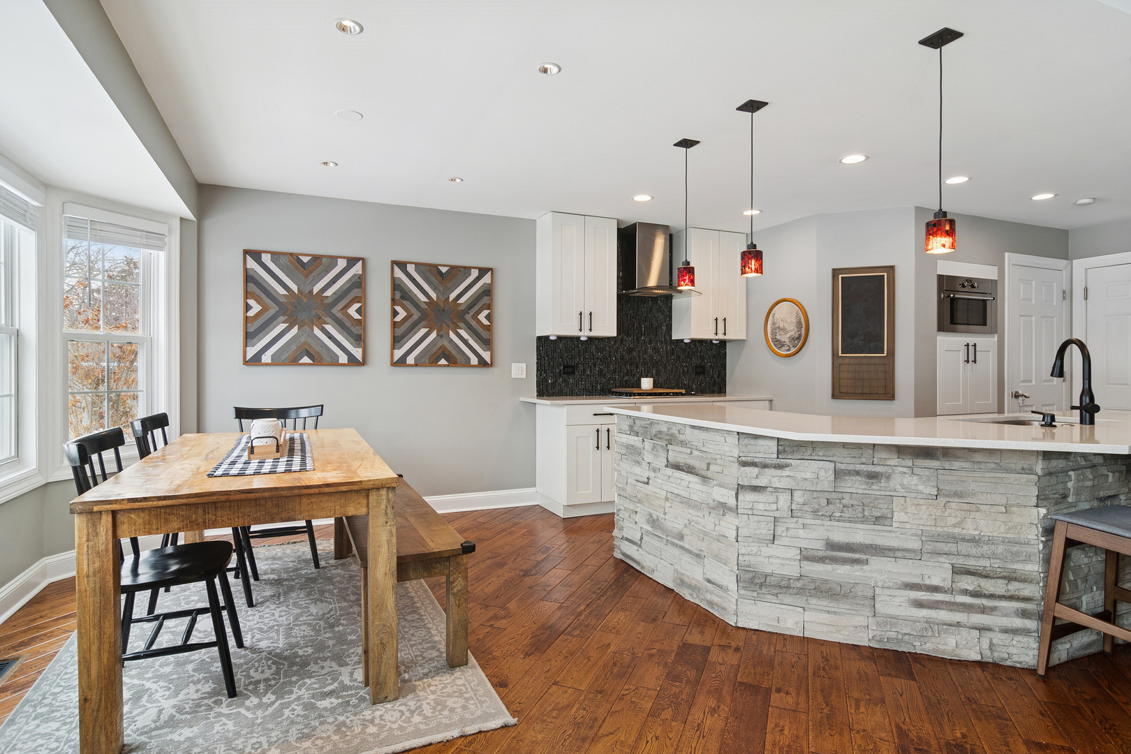469 Pheasant Ridge Road Lake Zurich, IL 60047 - Photo 8 of 20 a view of a kitchen with kitchen island a dining table chairs and a wooden floor