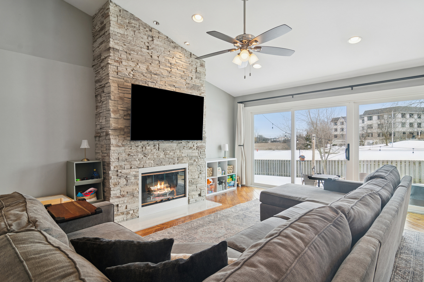 469 Pheasant Ridge Road Lake Zurich, IL 60047 - Photo 10 of 20 a living room with furniture a fireplace and a flat screen tv