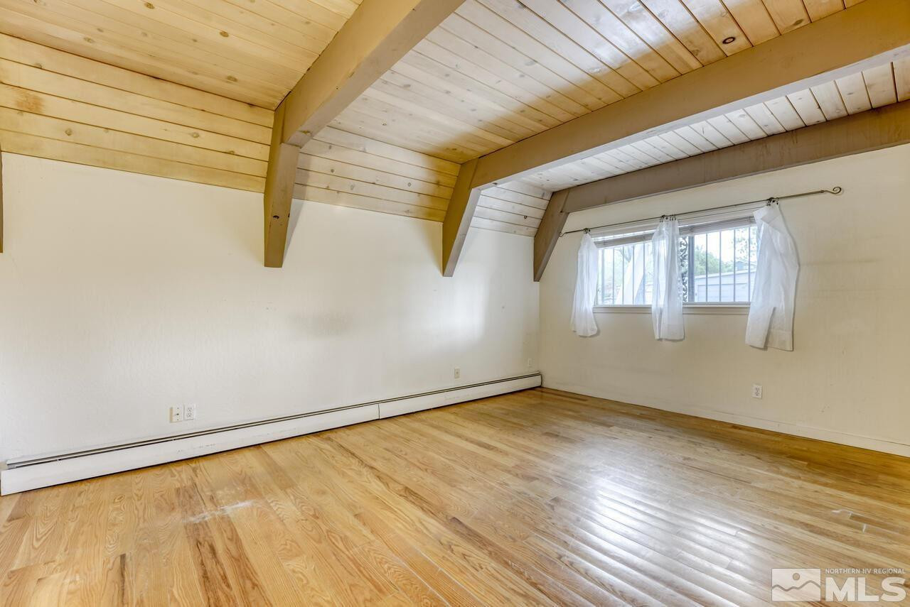 1940 Foothill Road Reno, NV 89511 - Photo 13 of 40 a view of an empty room with wooden floor and a window