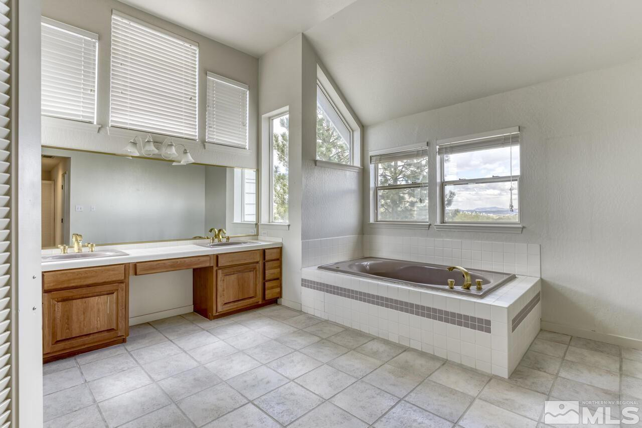 1940 Foothill Road Reno, NV 89511 - Photo 22 of 40 a spacious bathroom with a granite countertop tub sink and mirror
