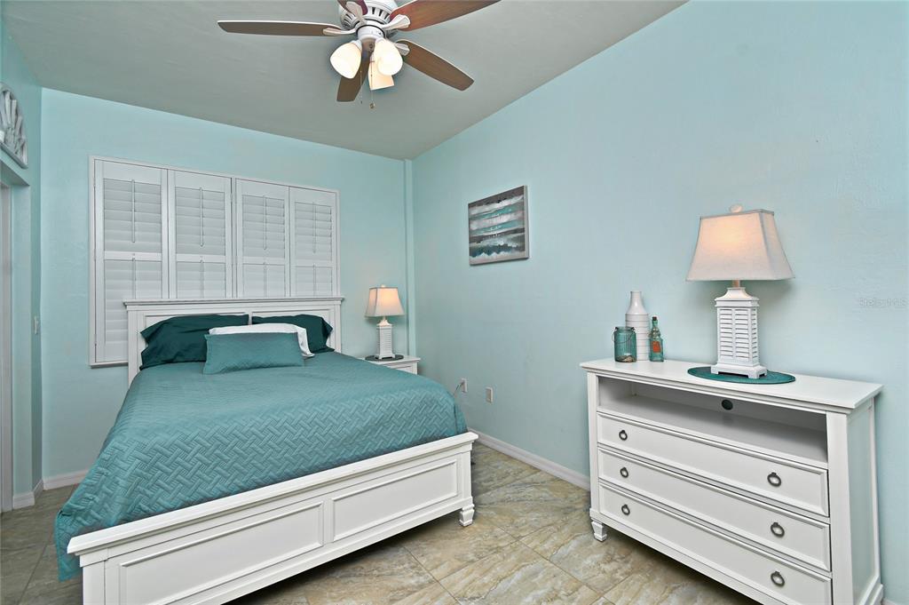 2060 Matecumbe Key Road, Unit 2102 Punta Gorda, FL 33955 - Photo 14 of 36 a bedroom with a bed and a chandelier