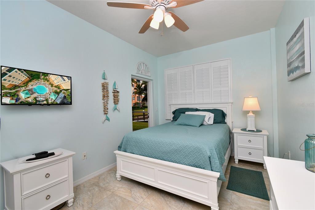 2060 Matecumbe Key Road, Unit 2102 Punta Gorda, FL 33955 - Photo 15 of 36 a bedroom with a bed and a flat tv screen on the dresser