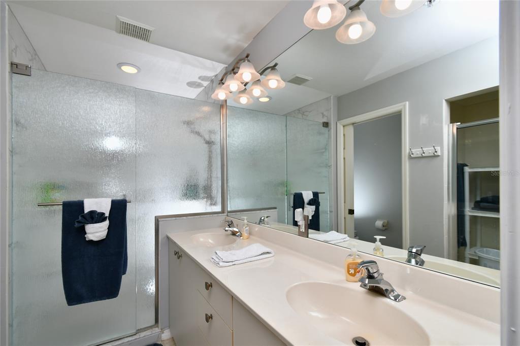 2060 Matecumbe Key Road, Unit 2102 Punta Gorda, FL 33955 - Photo 22 of 36 a bathroom with a sink vanity and a mirror