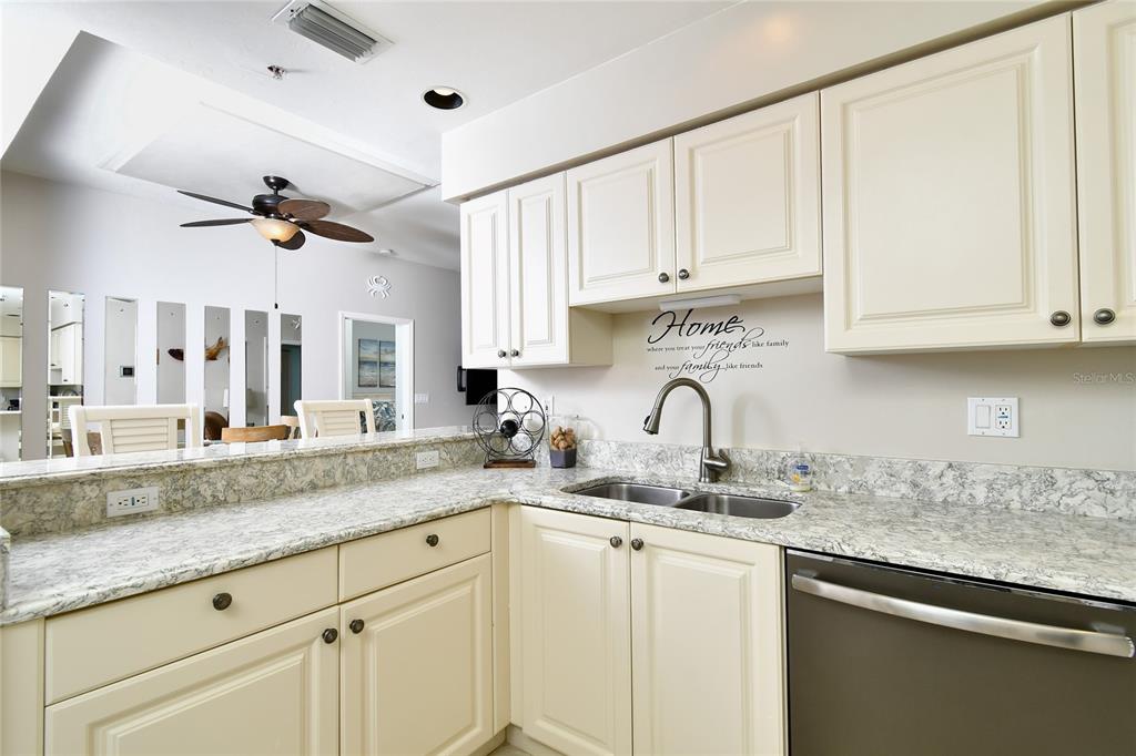 2060 Matecumbe Key Road, Unit 2102 Punta Gorda, FL 33955 - Photo 9 of 36 a kitchen with granite countertop white cabinets white appliances and a sink