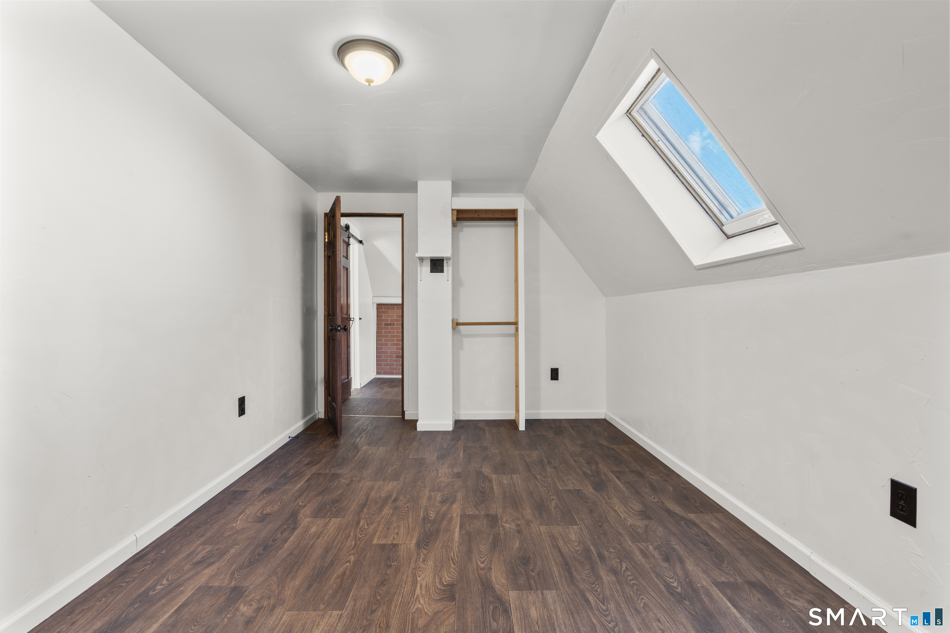 101 Wilcox Avenue Meriden, CT 06451 - Photo 16 of 43 a view of an empty room with wooden floor and a window