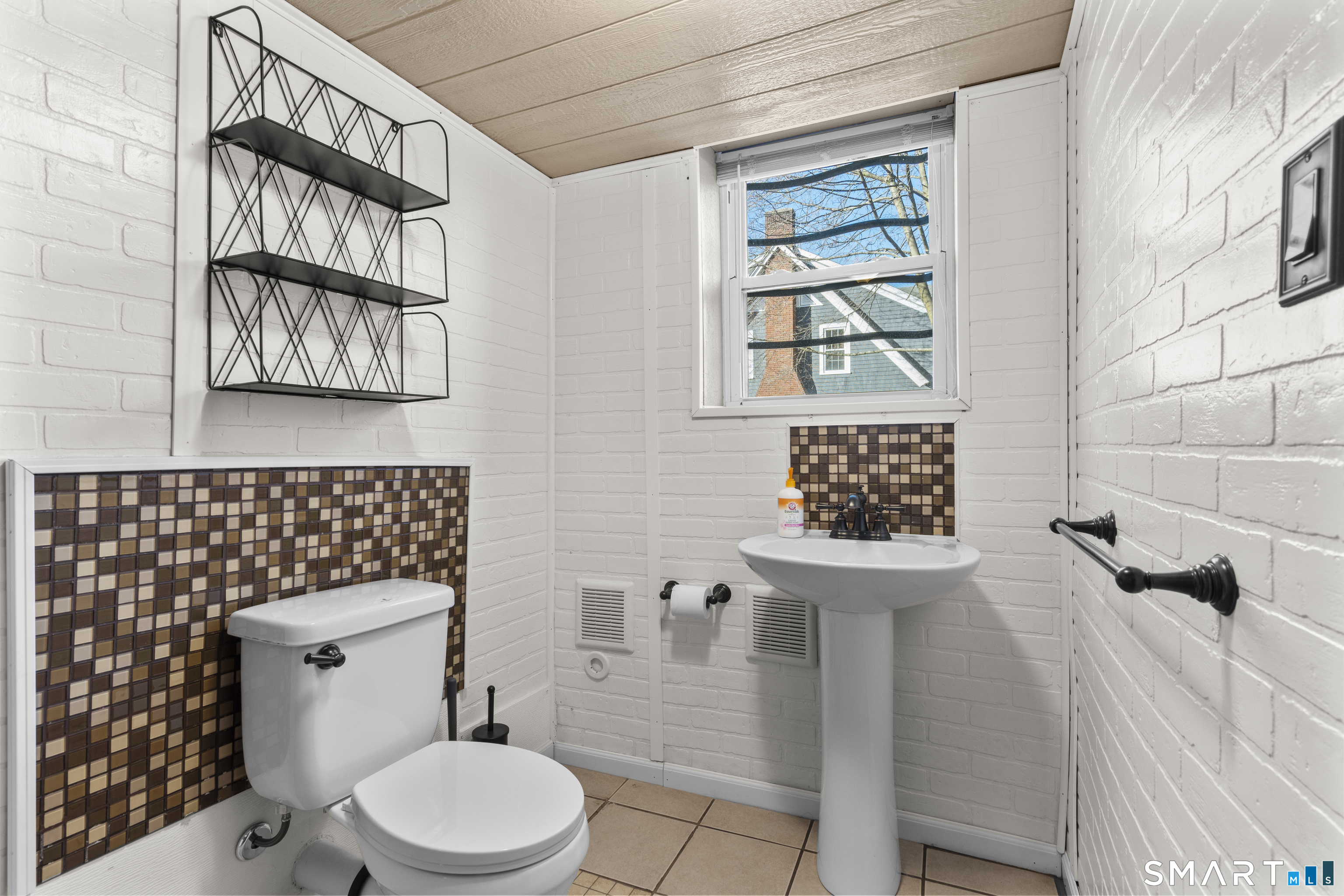 101 Wilcox Avenue Meriden, CT 06451 - Photo 27 of 43 a bathroom with a toilet a sink and a window