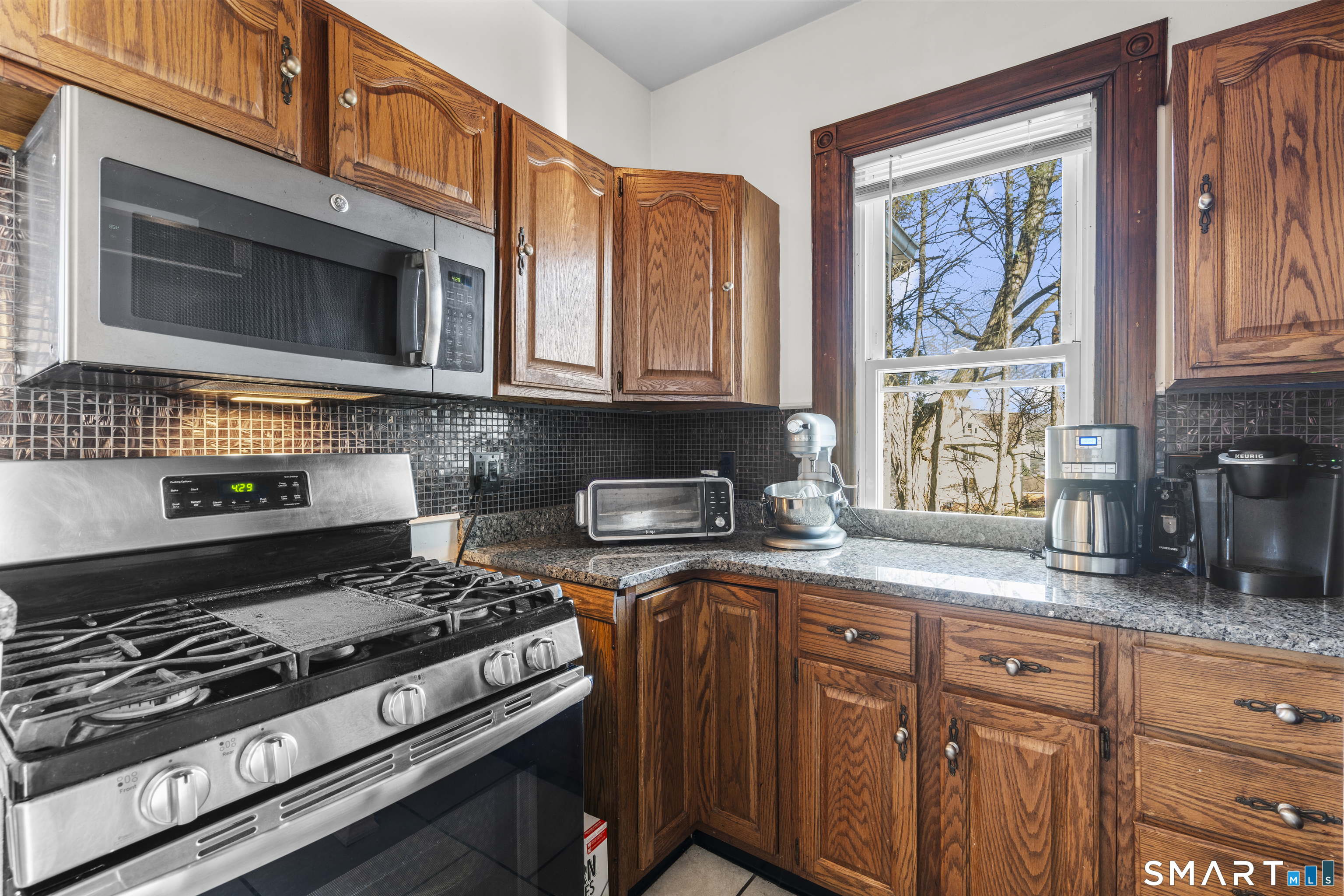 101 Wilcox Avenue Meriden, CT 06451 - Photo 30 of 43 a kitchen with granite countertop cabinets stainless steel appliances and a counter space