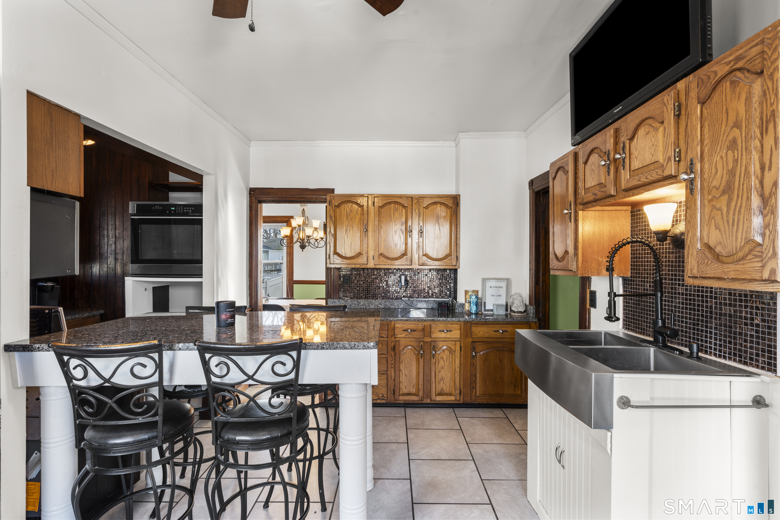 101 Wilcox Avenue Meriden, CT 06451 - Photo 31 of 43 a kitchen with stainless steel appliances granite countertop a stove a sink and a microwave