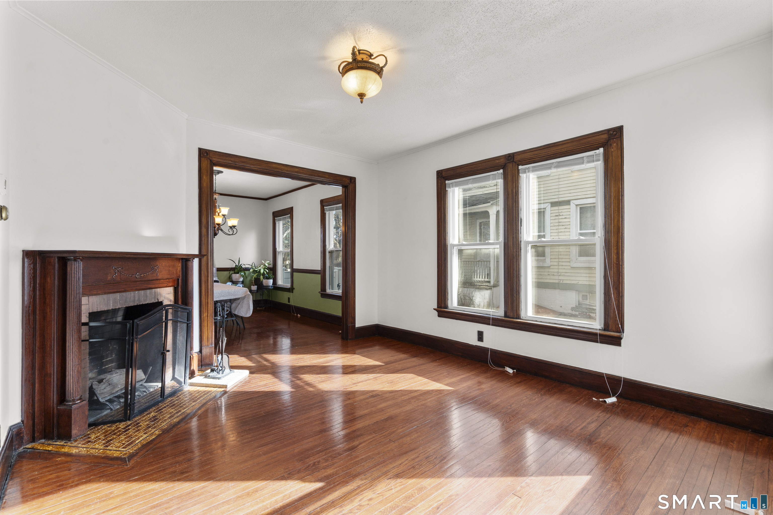 101 Wilcox Avenue Meriden, CT 06451 - Photo 33 of 43 a view of an empty room with exposed radiator and fireplace