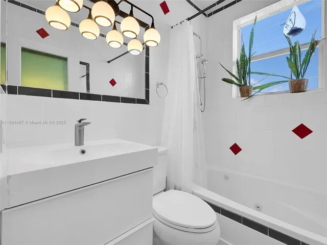 a bathroom with a sink mirror vanity and toilet