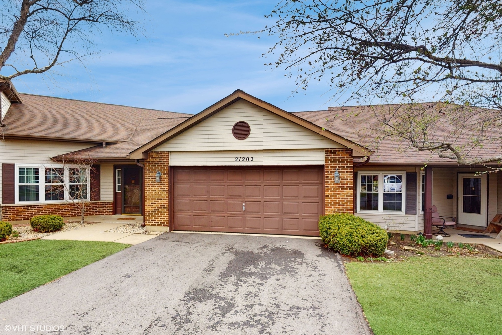 a front view of a house with a yard and garage