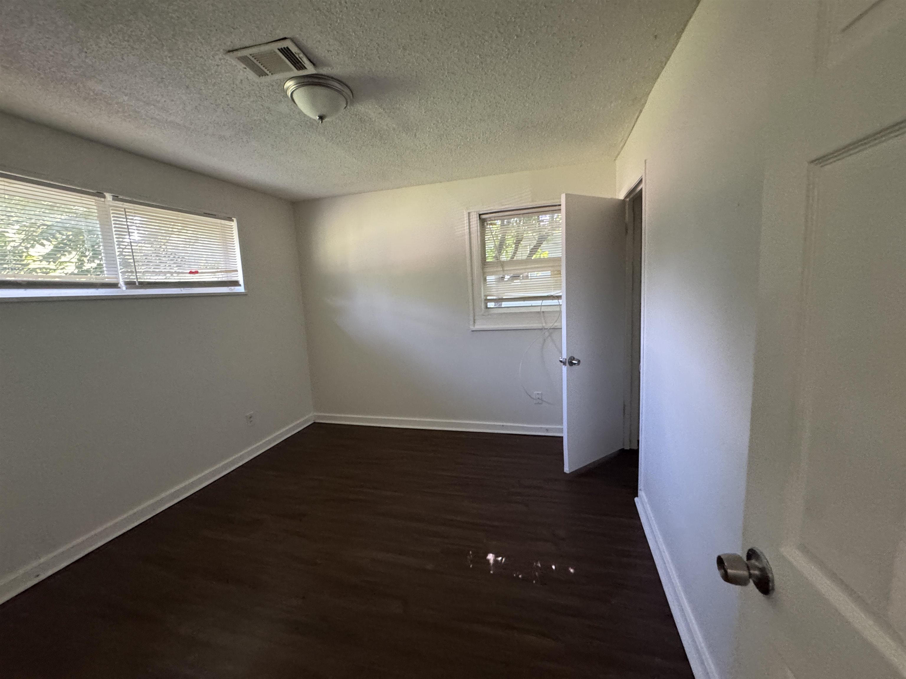 761 Harahan Road Memphis, TN 38109 - Photo 7 of 9 Room featuring dark wood-finish flooring, white baseboards, and light-colored walls