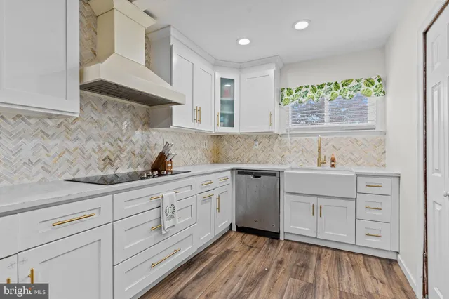 a kitchen with granite countertop white cabinets and white appliances