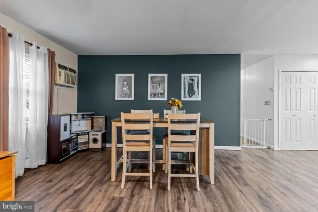 a dining room with furniture and wooden floor