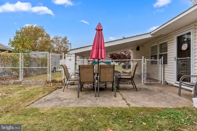 a view of a patio with a table and chairs