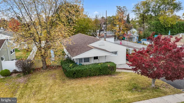 a view of a house with a yard and street