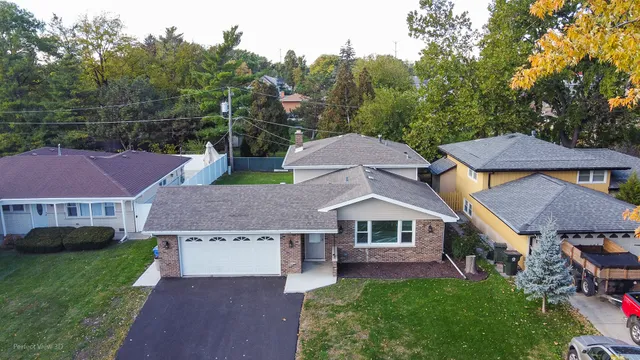 a aerial view of a house next to a yard